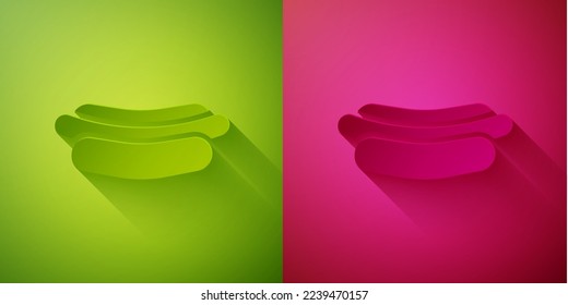 Paper cut Hotdog sandwich icon isolated on green and pink background. Sausage icon. Fast food sign. Paper art style. Vector Illustration