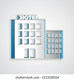 Paper cut Hotel building icon isolated on grey background. Paper art style. Vector Illustration