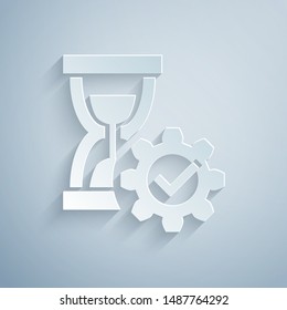 Paper cut Hourglass and gear icon isolated on grey background. Time Management symbol. Clock and gear icon. Productivity symbol. Paper art style. Vector Illustration