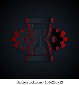 Paper cut Hourglass and gear icon isolated on black background. Time Management symbol. Clock and gear icon. Productivity symbol. Paper art style. Vector Illustration