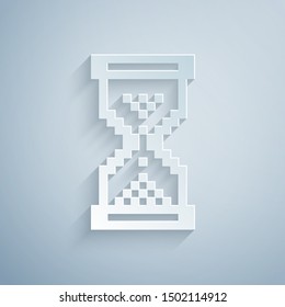 Paper cut Hourglass pixel with flowing sand icon isolated on grey background. Sand clock sign. Business and time management concept. Paper art style. Vector Illustration