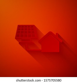 Paper cut House with solar panel icon isolated on red background. Ecology, solar renewable energy. Eco-friendly house. Environmental Protection. Paper art style. Vector Illustration