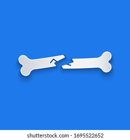 Paper cut Human broken bone icon isolated on blue background. Paper art style. Vector Illustration