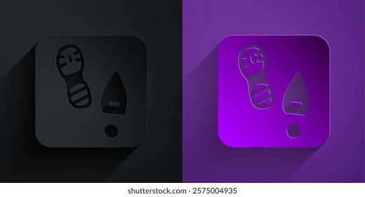 Paper cut Human footprints shoes icon isolated on black on purple background. Shoes sole. Paper art style. Vector