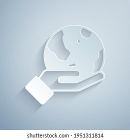 Paper cut Human hand holding Earth globe icon isolated on grey background. Save earth concept. Paper art style. Vector