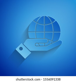 Paper cut Human hands holding Earth globe icon isolated on blue background. Save earth concept. Paper art style. Vector Illustration