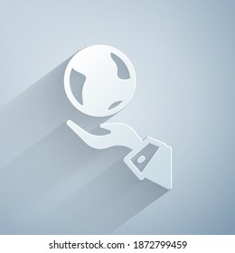 Paper cut Human hands holding Earth globe icon isolated on grey background. Save earth concept. Paper art style. Vector