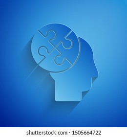 Paper cut Human head puzzles strategy icon isolated on blue background. Thinking brain sign. Symbol work of brain. Paper art style. Vector Illustration