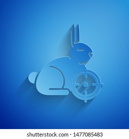 Paper cut Hunt on rabbit with crosshairs icon isolated on blue background. Hunting club logo with rabbit and target. Rifle lens aiming a hare. Paper art style. Vector Illustration