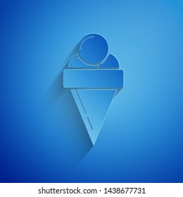Paper cut Ice cream in waffle cone icon isolated on blue background. Sweet symbol. Paper art style. Vector Illustration