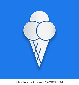 Paper cut Ice cream in waffle cone icon isolated on blue background. Sweet symbol. Paper art style. Vector Illustration