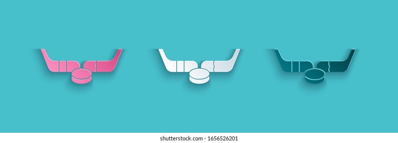 Paper cut Ice hockey sticks and puck icon isolated on blue background. Game start. Paper art style. Vector Illustration