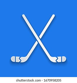 Paper cut Ice hockey sticks icon isolated on blue background. Paper art style. Vector Illustration