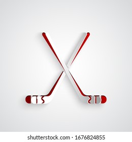 Paper cut Ice hockey sticks icon isolated on grey background. Paper art style. Vector Illustration