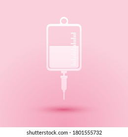 Paper cut IV bag icon isolated on pink background. Blood bag icon. Donate blood concept. The concept of treatment and therapy, chemotherapy. Paper art style. Vector.