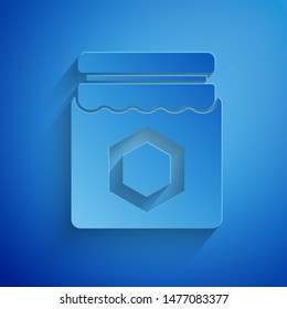 Paper cut Jar of honey icon isolated on blue background. Food bank. Sweet natural food symbol. Paper art style. Vector Illustration