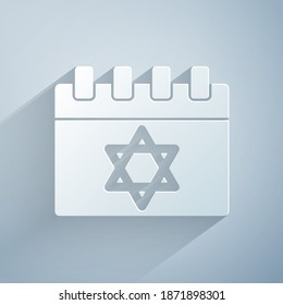 Paper cut Jewish calendar with star of david icon isolated on grey background. Hanukkah calendar day. Paper art style. Vector