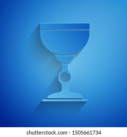 Paper cut Jewish goblet icon isolated on blue background. Jewish wine cup for kiddush. Kiddush cup for Shabbat. Paper art style. Vector Illustration