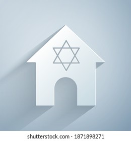 Paper cut Jewish synagogue building or jewish temple icon isolated on grey background. Hebrew or judaism construction with David star. Paper art style. Vector