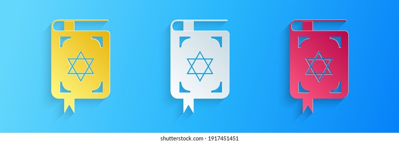 Paper cut Jewish torah book icon isolated on blue background. Book of the Pentateuch of Moses. On the cover of the Bible is the image of the Star of David. Paper art style. Vector.