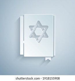 Paper cut Jewish torah book icon isolated on grey background. Pentateuch of Moses. On the cover of the Bible is the image of the Star of David. Paper art style. Vector.