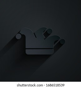 Paper cut Joker playing card icon isolated on black background. Jester hat with bells. Casino gambling. Paper art style. Vector Illustration