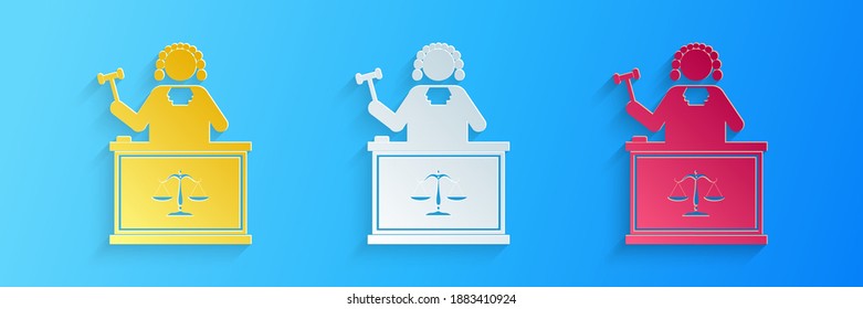 Paper cut Judge with gavel on table icon isolated on blue background. Paper art style. Vector.