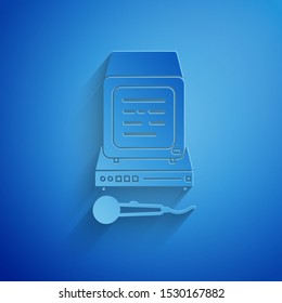 Paper cut Karaoke icon isolated on blue background. Microphone and monitor. Paper art style. Vector Illustration
