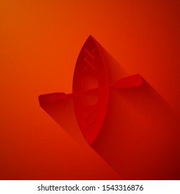 Paper cut Kayak and paddle icon isolated on red background. Kayak and canoe for fishing and tourism. Outdoor activities. Paper art style. Vector Illustration