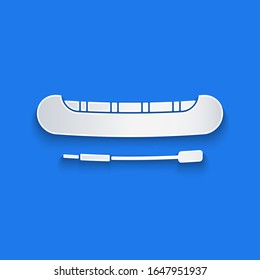 Paper cut Kayak and paddle icon isolated on blue background. Kayak and canoe for fishing and tourism. Outdoor activities. Paper art style. Vector Illustration