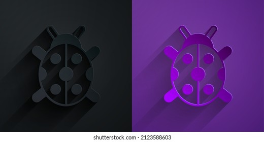 Paper cut Ladybug icon isolated on black on purple background. Paper art style. Vector