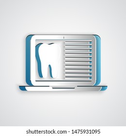 Paper cut Laptop with dental card or patient medical records icon isolated on grey background. Dental insurance. Dental clinic report. Paper art style. Vector Illustration