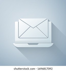 Paper cut Laptop with envelope and open email on screen icon isolated on grey background. Email marketing, internet advertising concepts. Paper art style. Vector Illustration