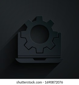 Paper cut Laptop and gear icon isolated on black background. Adjusting app, setting options, maintenance, repair, fixing. Paper art style. Vector Illustration