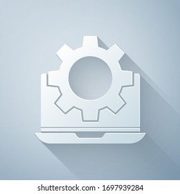 Paper cut Laptop and gear icon isolated on grey background. Adjusting app, setting options, maintenance, repair, fixing. Paper art style. Vector Illustration