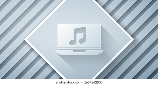 Paper cut Laptop with music note symbol on screen icon isolated on grey background. Paper art style. Vector Illustration