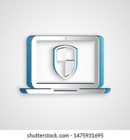 Paper cut Laptop protected with shield icon isolated on grey background. Internet security. PC security, firewall technology, privacy safety. Paper art style. Vector Illustration