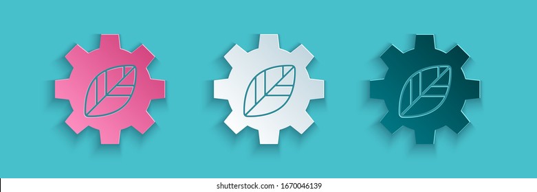 Paper cut Leaf plant ecology in gear machine icon isolated on blue background. Eco friendly technology. World Environment day label. Paper art style. Vector Illustration