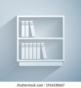 Paper cut Library bookshelf icon isolated on grey background. Paper art style. Vector