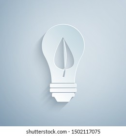 Paper cut Light bulb with leaf icon isolated on grey background. Eco energy concept. Alternative energy concept. Paper art style. Vector Illustration