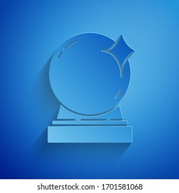 Paper cut Magic ball icon isolated on blue background. Crystal ball. Paper art style. Vector Illustration