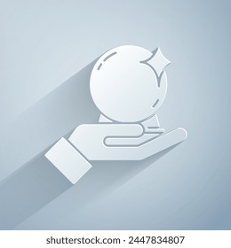 Paper cut Magic ball on hand icon isolated on grey background. Crystal ball. Paper art style. Vector Illustration