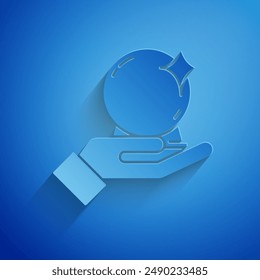 Paper cut Magic ball on hand icon isolated on blue background. Crystal ball. Paper art style. Vector Illustration