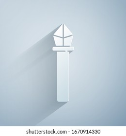 Paper cut Magic staff icon isolated on grey background. Magic wand, scepter, stick, rod. Paper art style. Vector Illustration