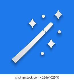 Paper cut Magic wand icon isolated on blue background. Star shape magic accessory. Magical power. Paper art style. Vector Illustration