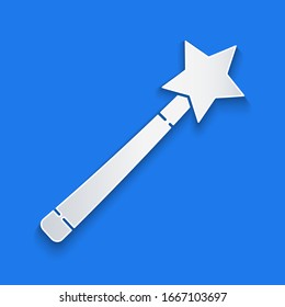 Paper cut Magic wand icon isolated on blue background. Star shape magic accessory. Magical power. Paper art style. Vector Illustration