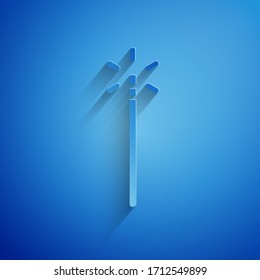 Paper cut Magic wand icon isolated on blue background. Star shape magic accessory. Magical power. Paper art style. Vector Illustration