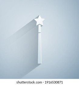 Paper cut Magic wand icon isolated on grey background. Star shape magic accessory. Magical power. Paper art style. Vector