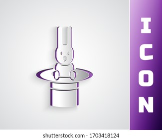 Paper cut Magician hat and rabbit icon isolated on grey background. Magic trick. Mystery entertainment concept. Paper art style. Vector Illustration