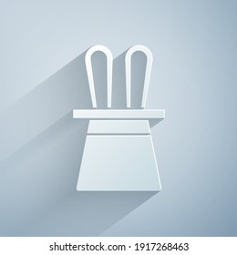 Paper cut Magician hat and rabbit ears icon isolated on grey background. Magic trick. Mystery entertainment concept. Paper art style. Vector
